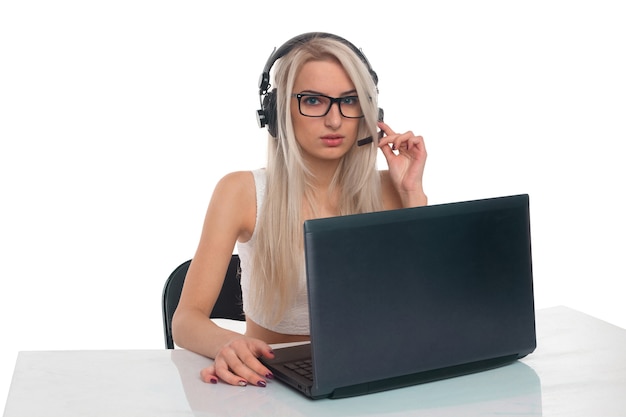 Girl with headphones working at a laptop