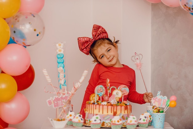 Girl with her birthday cake, happy birthday card, a cute little girl celebrates her birthday surrounded by gifts. high-quality photo
