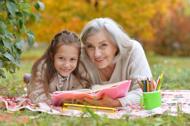 Girl with her grandmother reading