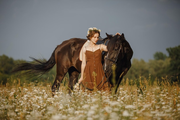 A girl with a horse a brown dress a man in nature with an animal