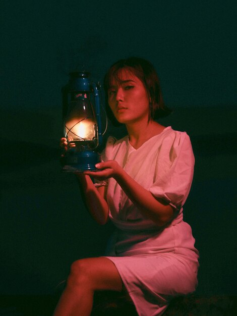 Photo girl with lamp  night portrait