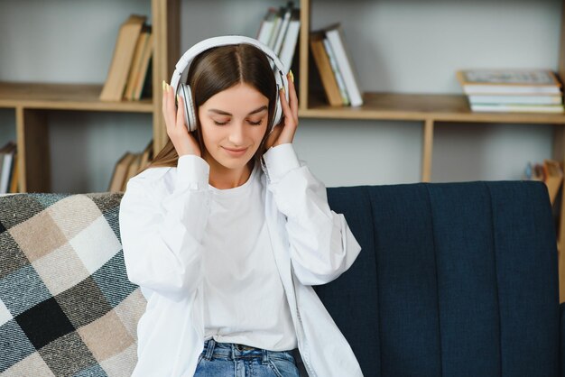 Girl with a laptop and headphones listens to music