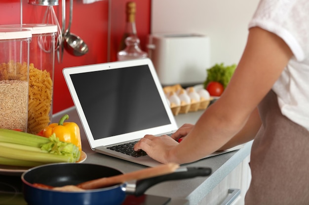 girl with laptop on kitchen food blogger concept