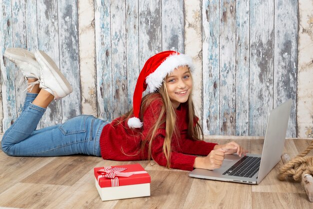 Girl with a laptop and a Santa's hat