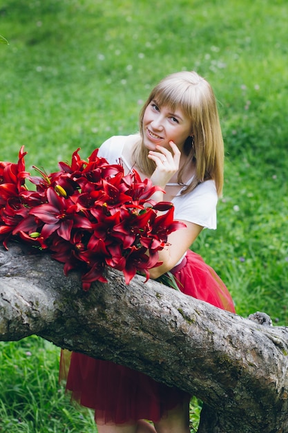 Girl with a large bouquet of purple lilies