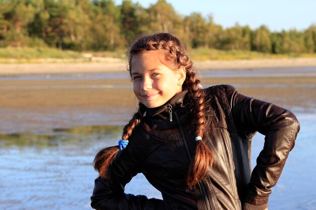 A girl with long brown and with a cheerful smile