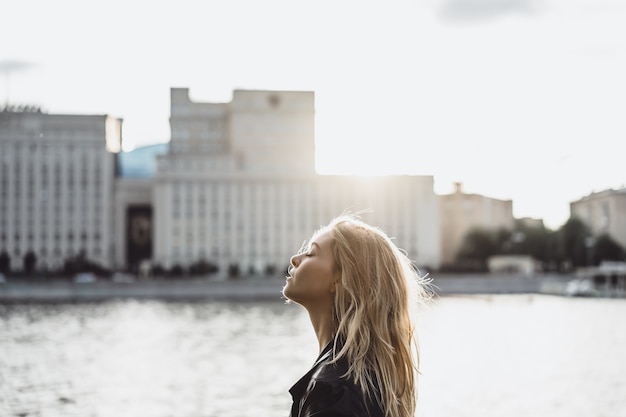 Girl with long hair on the background of the city.