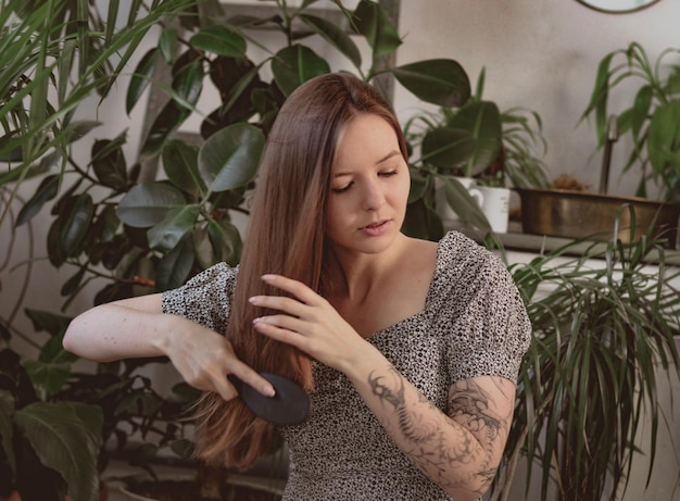 Girl with long hair on the background of foliage