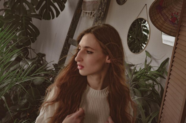 Girl with long hair on the background of foliage