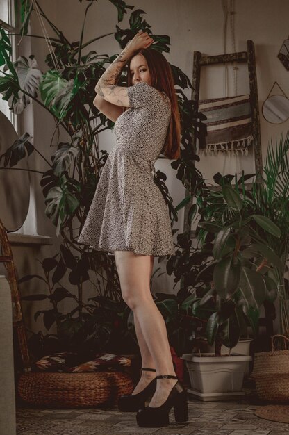 Girl with long hair on the background of foliage