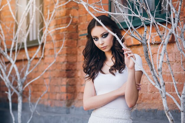 Girl with long hair in elegant white dress