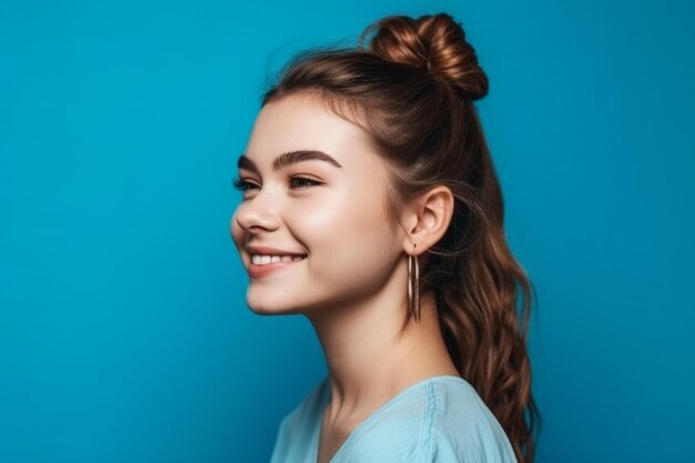 A girl with long hair is smiling on a blue background.