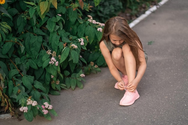 Girl with long hair ties shoelaces