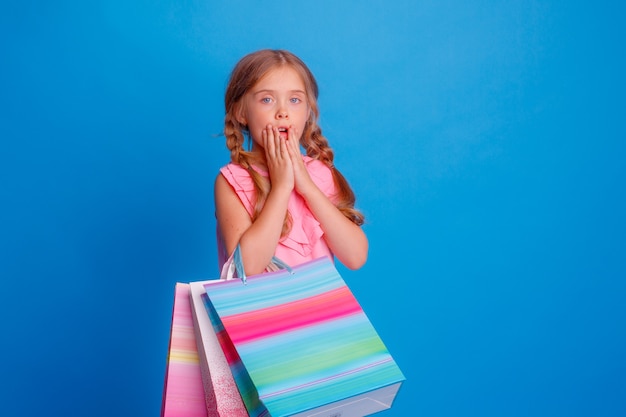 A girl with a lot of shopping bags is upset