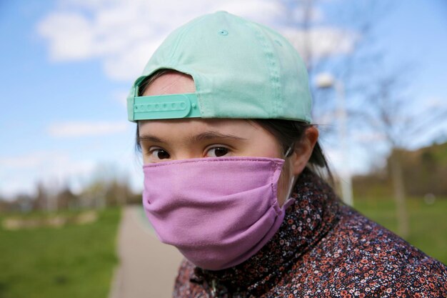 Photo girl with a mask on her face in the park