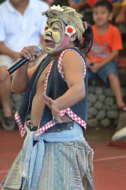 a girl with a mask that says clown on it