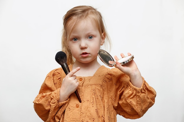 girl with a mirror and a brush on a white background