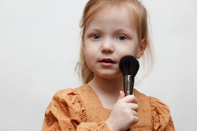 girl with a mirror and a brush on a white background