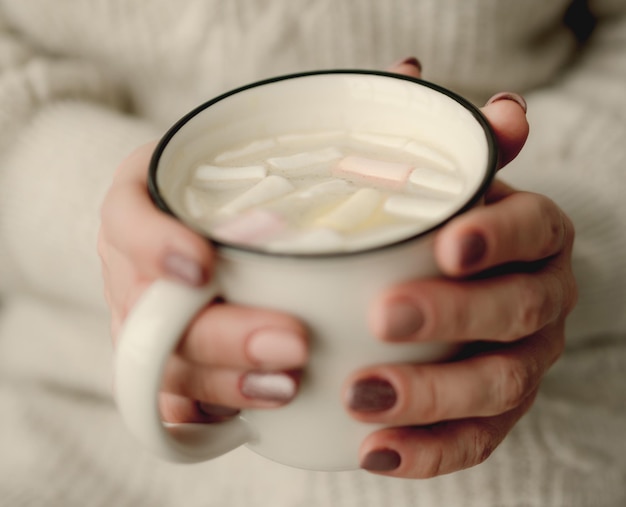 Girl with mug filled with cocoa