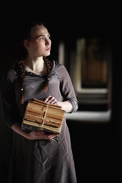 A girl with old books in the old house