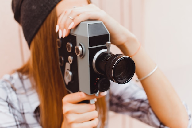 Girl with an old camcorder close up