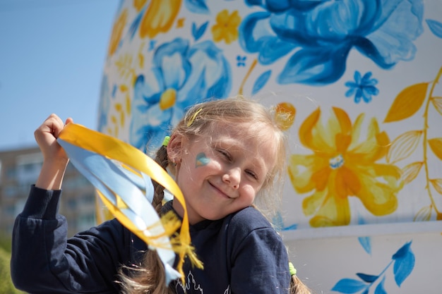 Girl with painted Ukraine flag yellow and blue Stop the war and the power of Ukraine patriotism