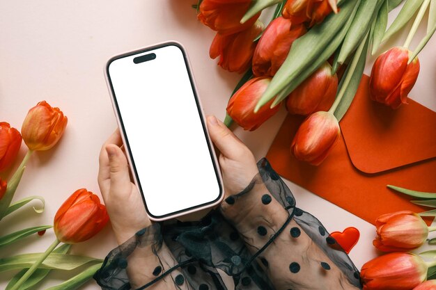 Girl with a phone in her hands with an isolated screen on a background of flowers