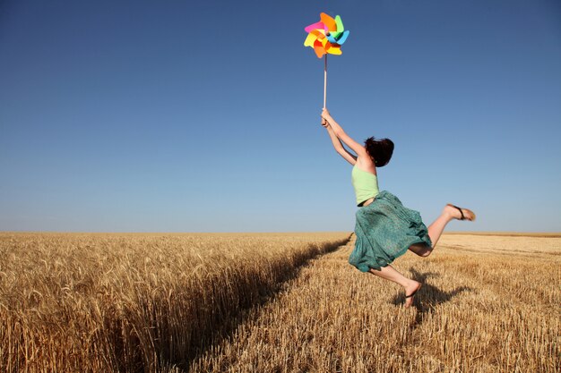 Girl with pinwheel at county side field