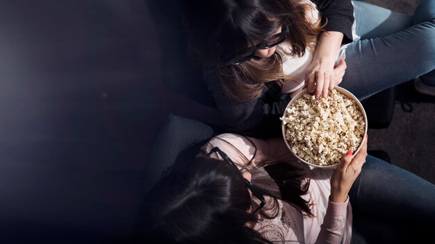 Ragazza con popcorn nel cinema