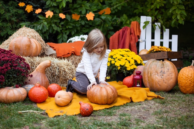 Girl with pumpkin outdoors