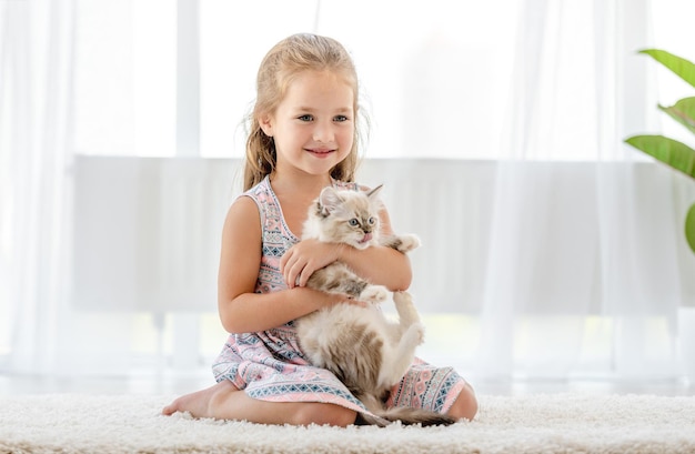 Girl with ragdoll kitten