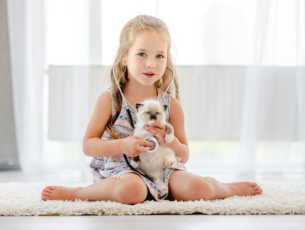 Girl with ragdoll kitten