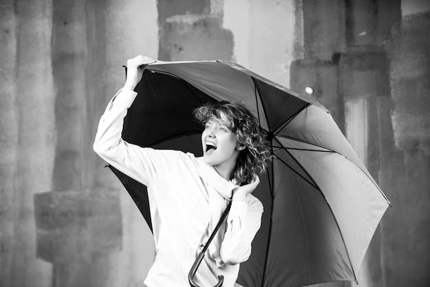 Girl with rainbow umbrella at rain weather Rainy autumn mood woman