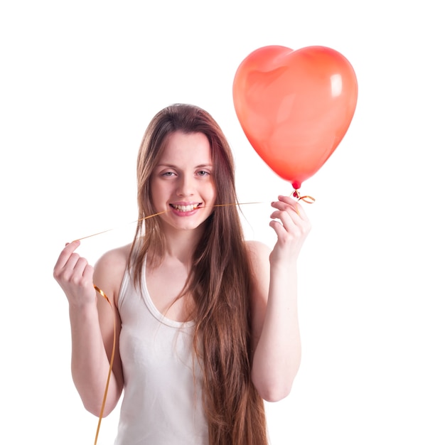 Girl with red balloon heart isolated on white