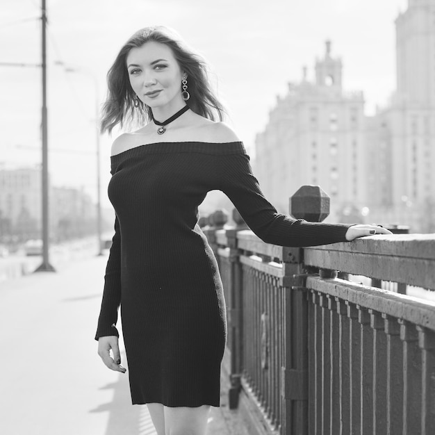 Girl with red hair in a black dress.