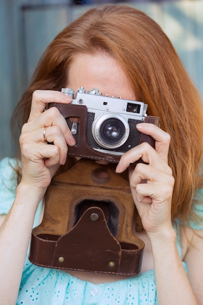 Girl with retro camera. Vintage.