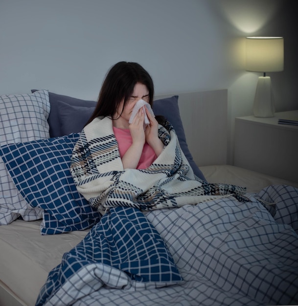 Girl with runny nose in bed