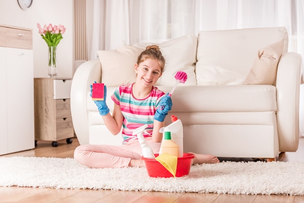 Girl with set of cleaning tools