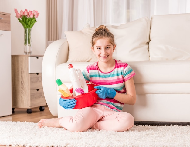 Girl with set of cleaning tools