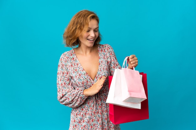 Girl with shopping bags over isolated background