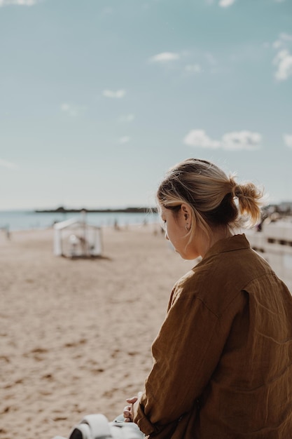 Girl with short hair sitting on the beach