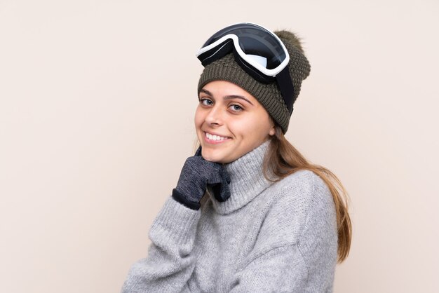 Photo girl with snow glasses over isolated wall