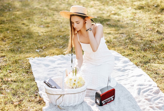 Girl with a straw hat in the spring in the park