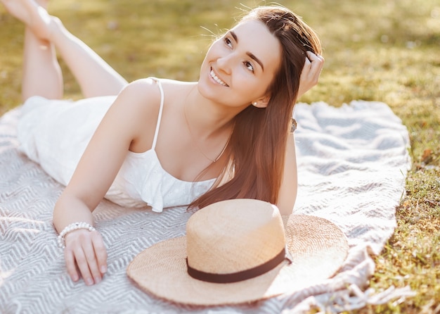 Girl with a straw hat in the spring in the park