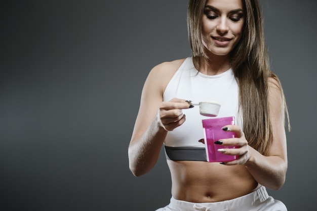 Girl with supplement whey protein shake powder