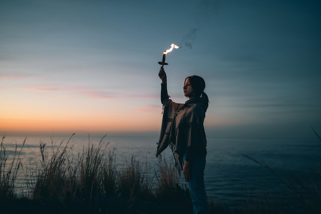 Girl with torch and arm to the sky
