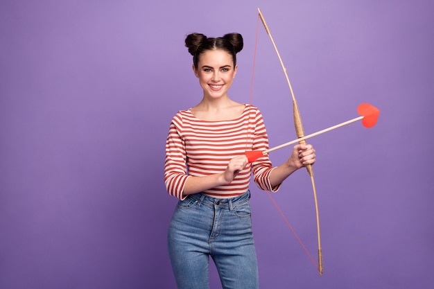 girl with trendy hairstyle holding bow and arrows