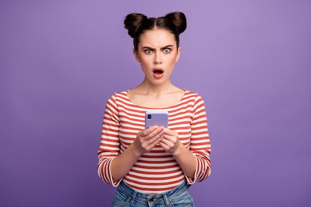 girl with trendy hairstyle using phone isolated on purple