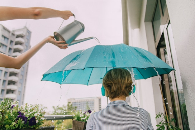 Girl with turquoise umbrella in headphones. 