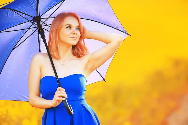 girl with an umbrella in a summer field of flowers, country female nature yellow field